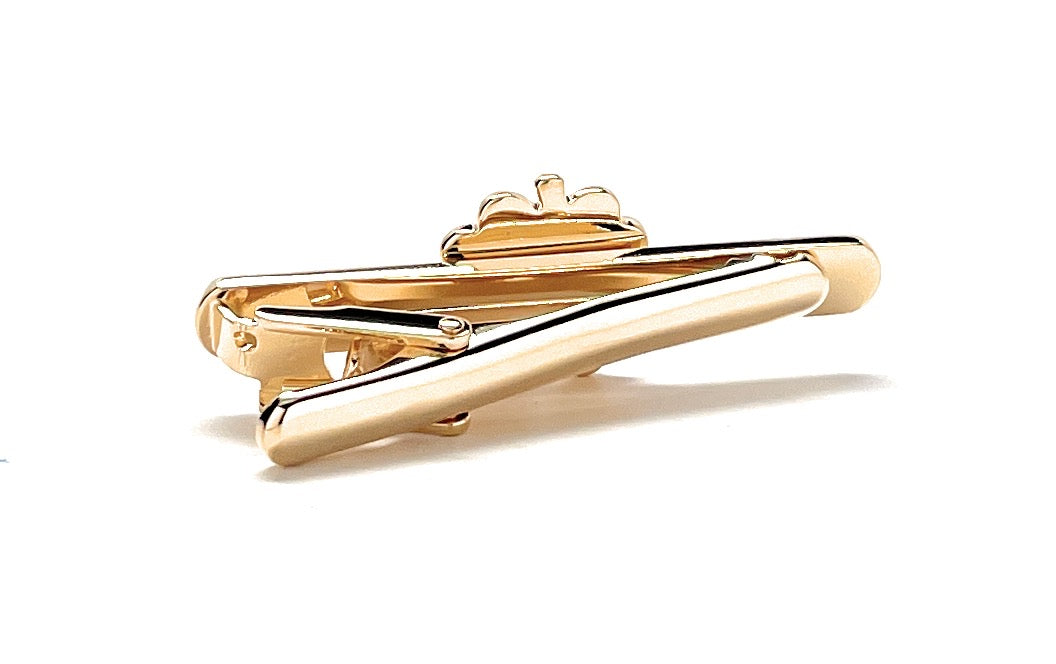 Gold tie clip on a white background