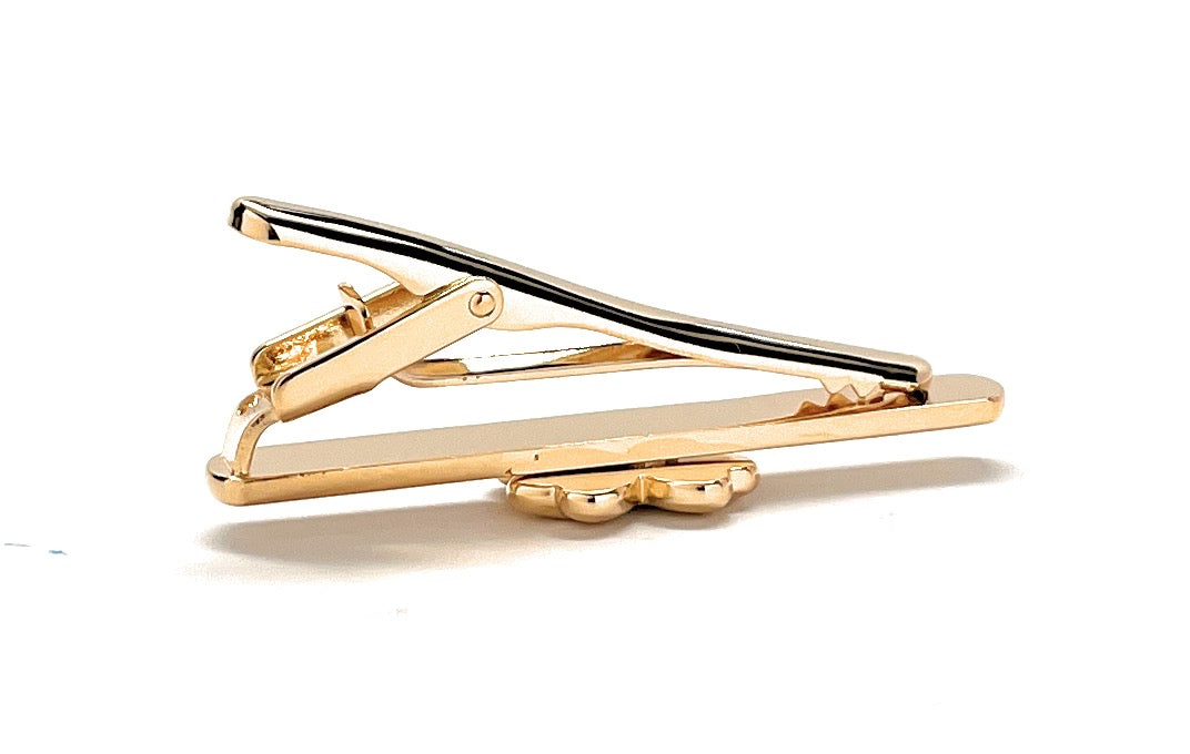 Gold tie clip on a white background