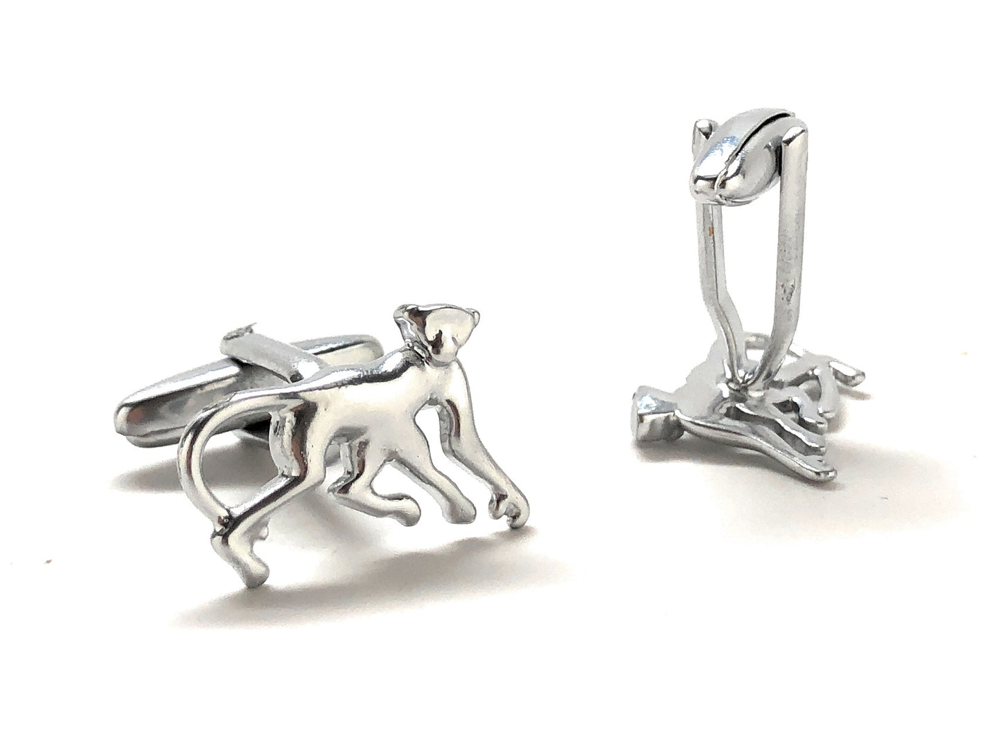 Silver monkey-shaped cufflinks on a white background