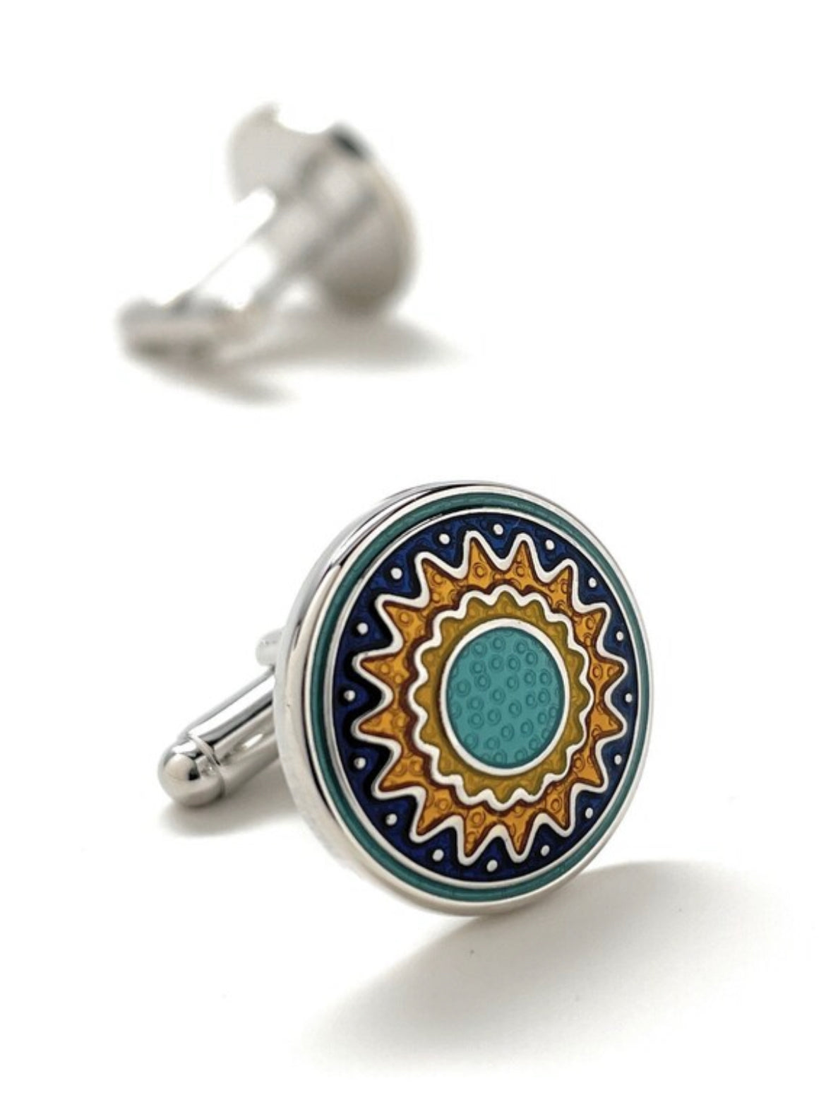 Cufflinks with a decorative design on a white background