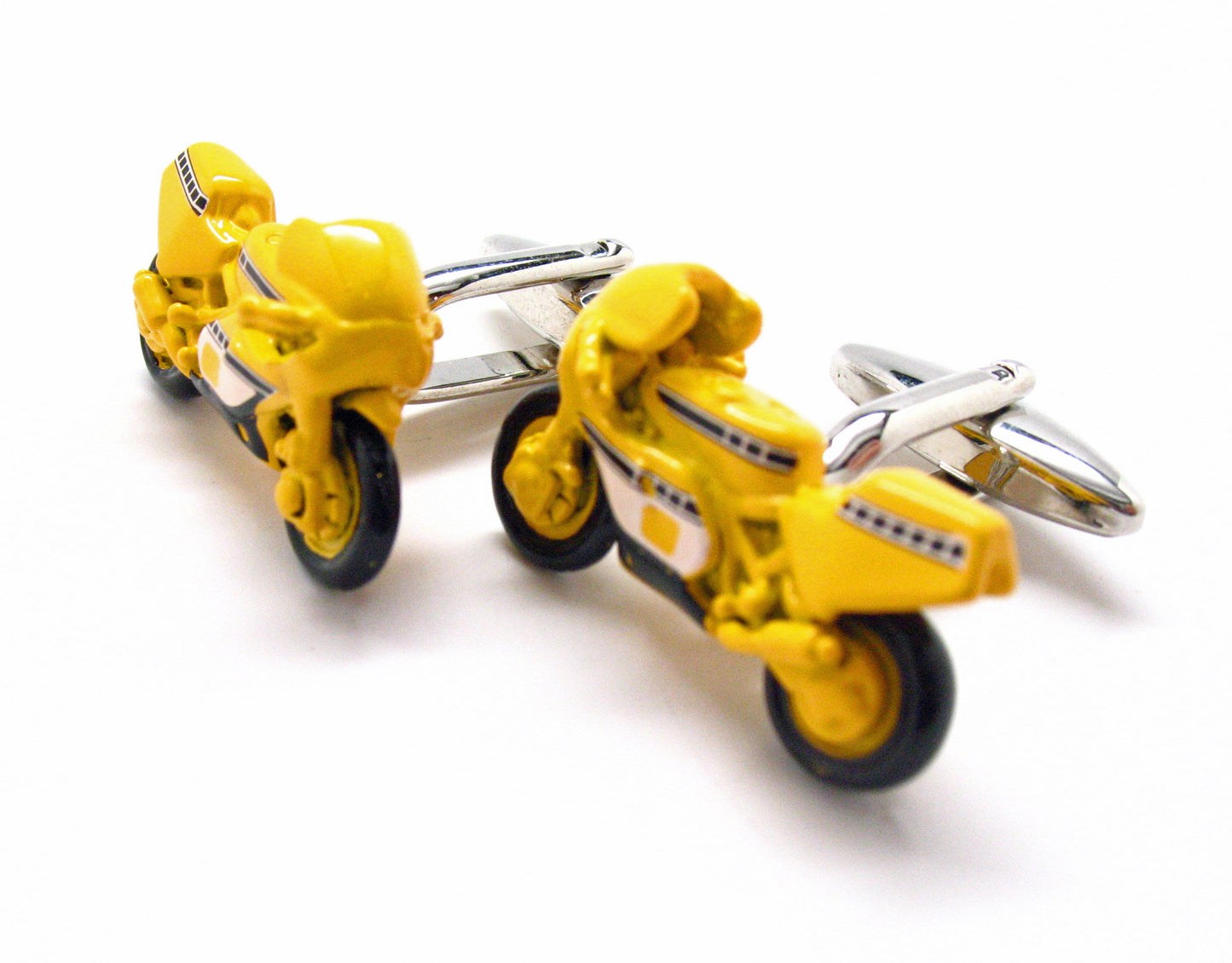 Yellow motorcycle-shaped cufflinks on a white background