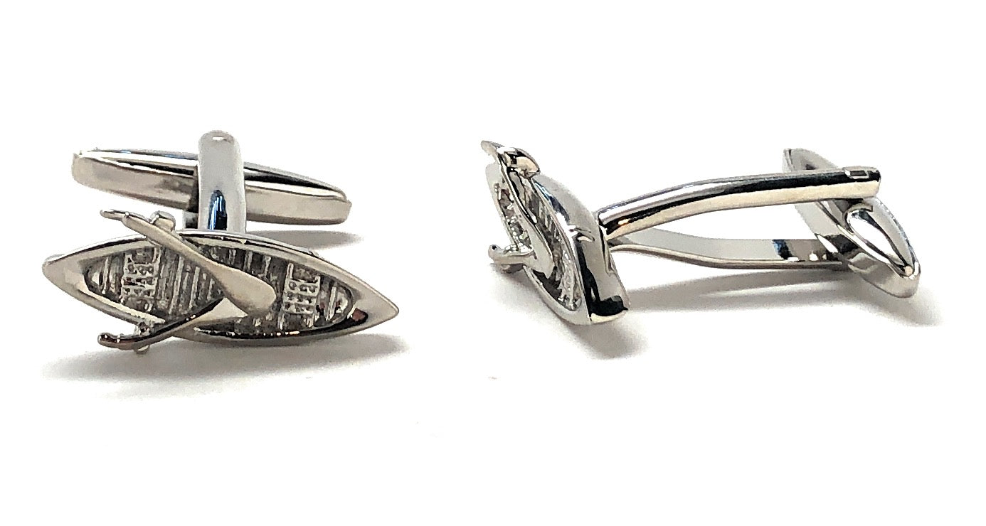 Silver cufflinks with intricate design on a white background