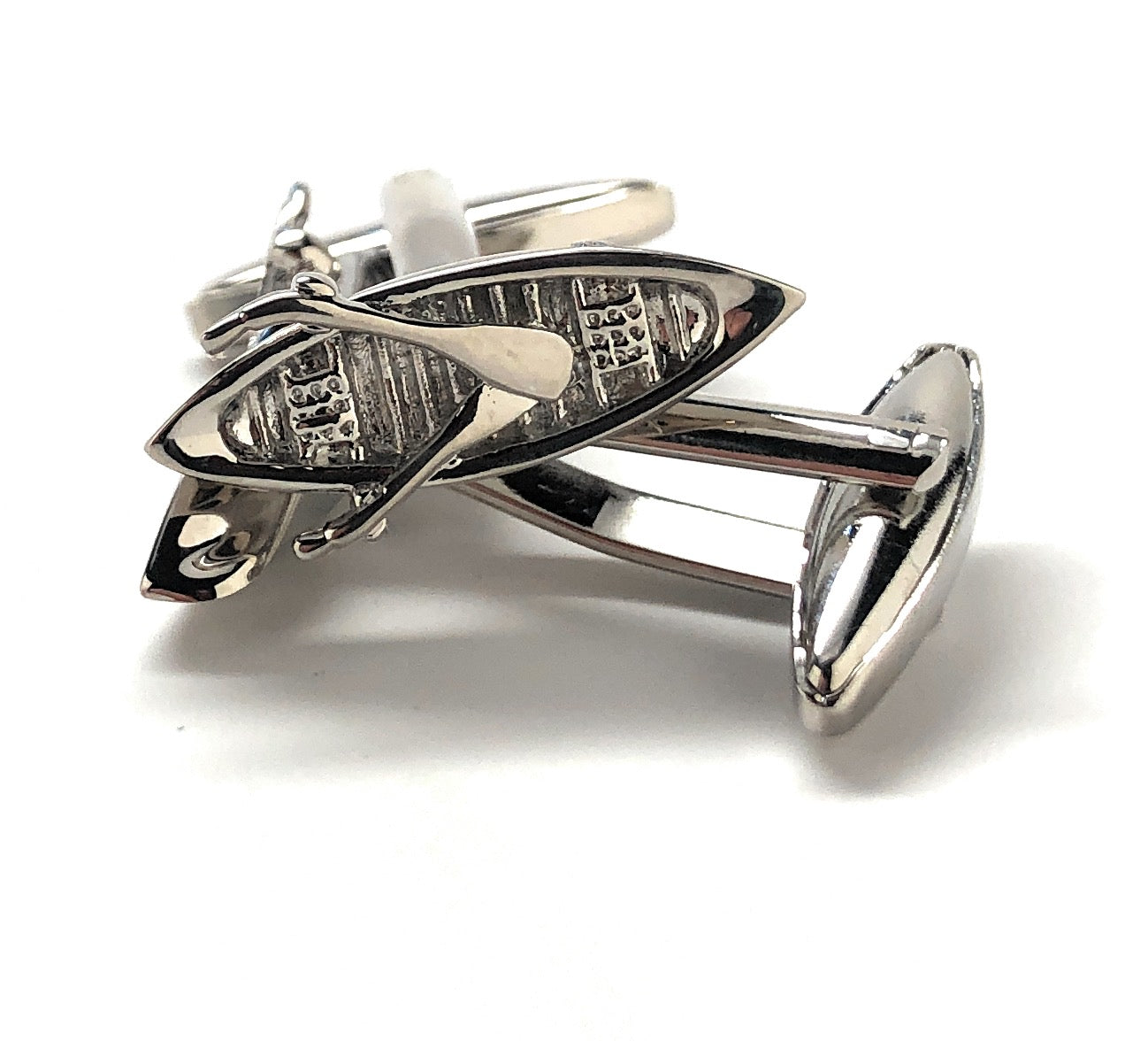 Silver surfboard cufflinks on a white background