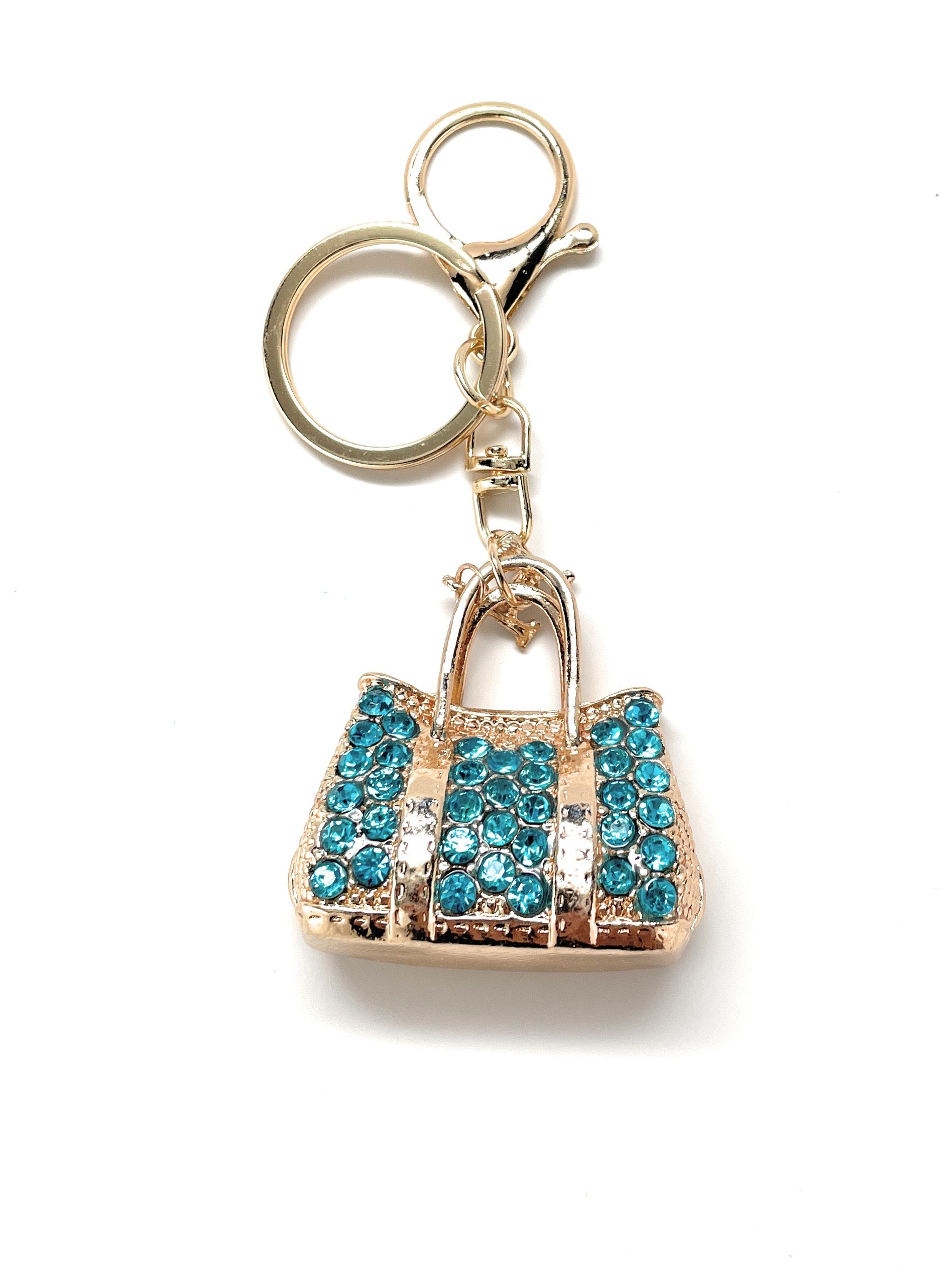 A blue and gold purse keychain with a lobster clasp and crystal embellishments.