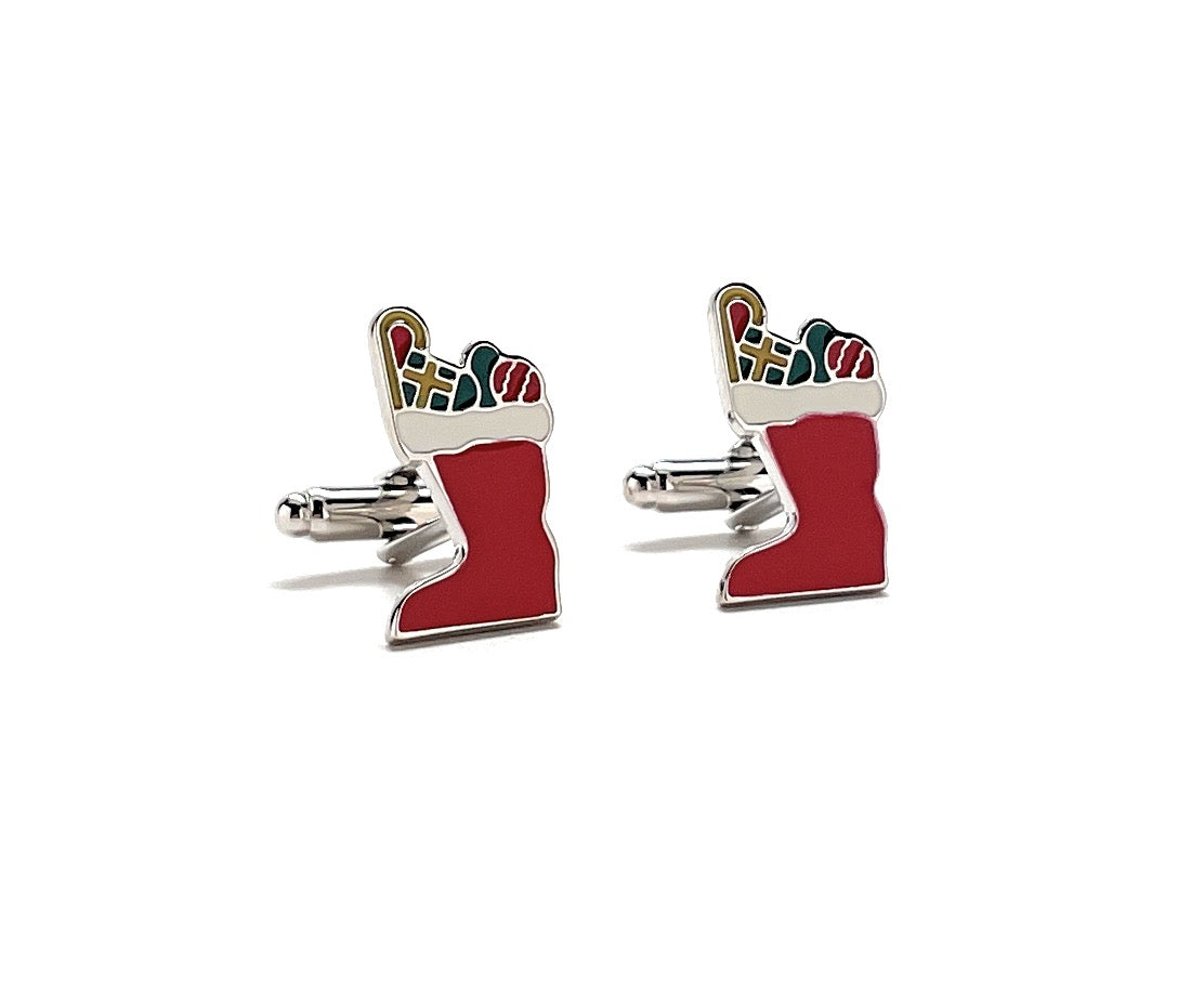 Red stocking cufflinks with colorful accents on a white background