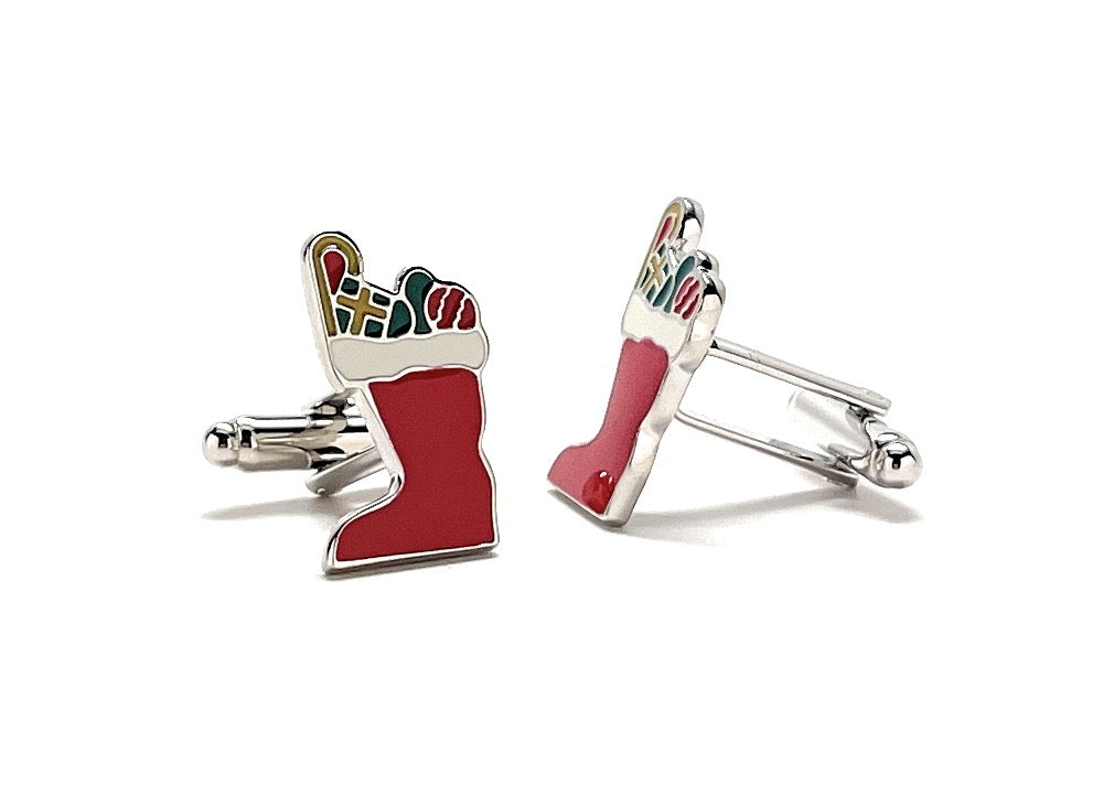 Red stocking and candy cane cufflinks on a white background