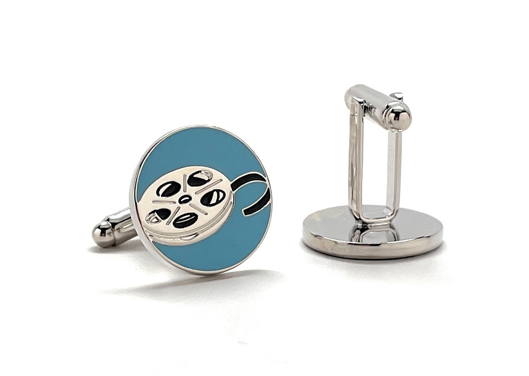Cufflinks with film reel design on a blue background