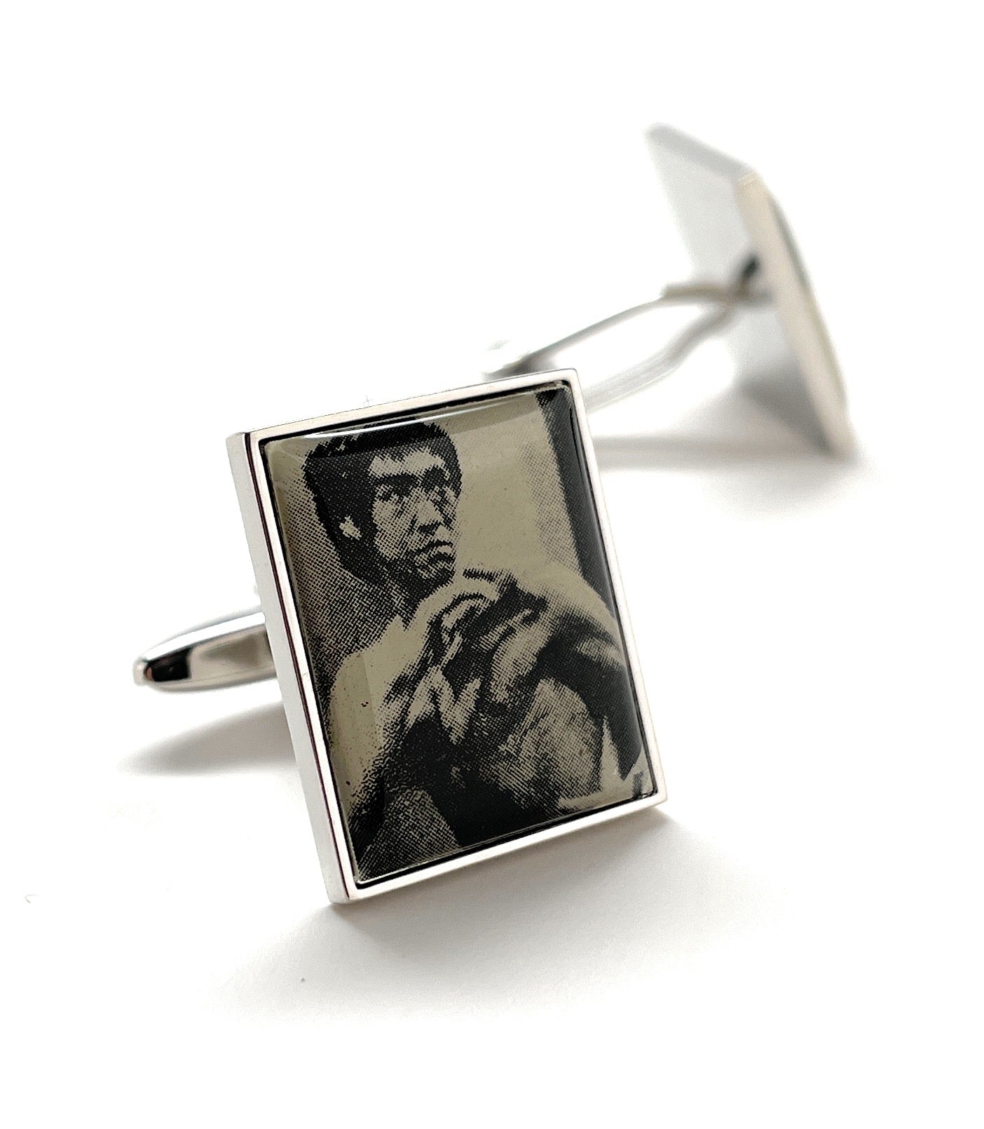 Cufflinks with a black and white portrait of a person on a white background