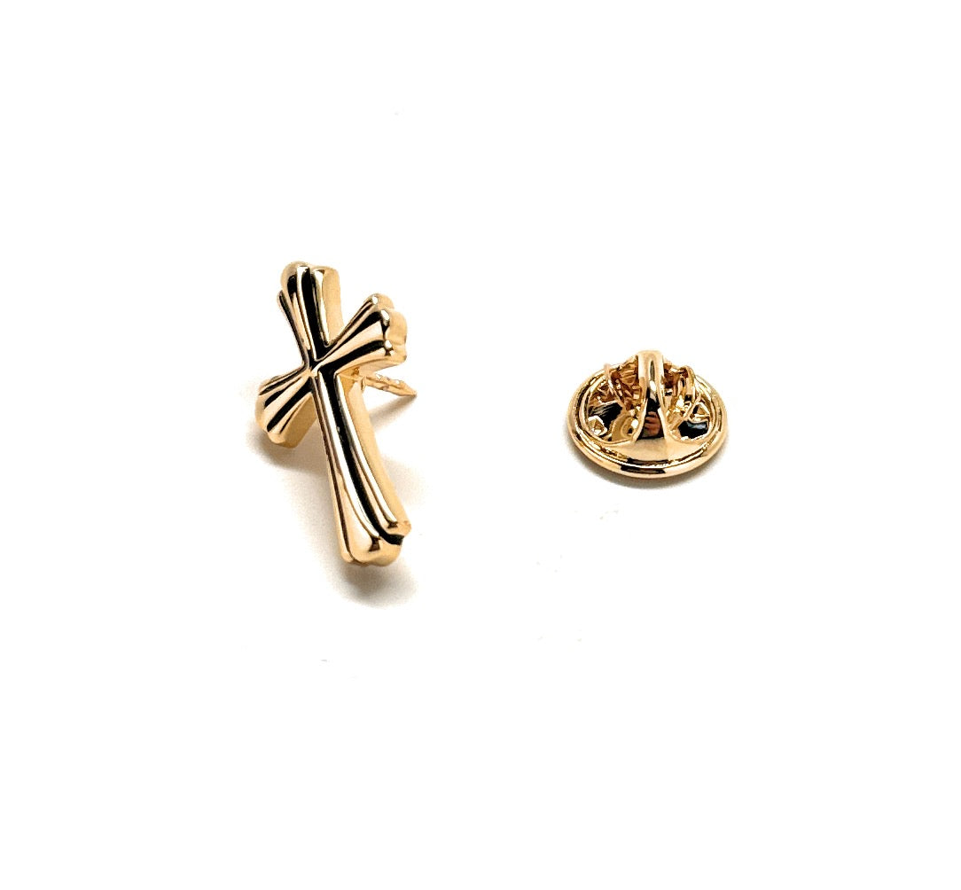 Gold cross-shaped earring on a white background