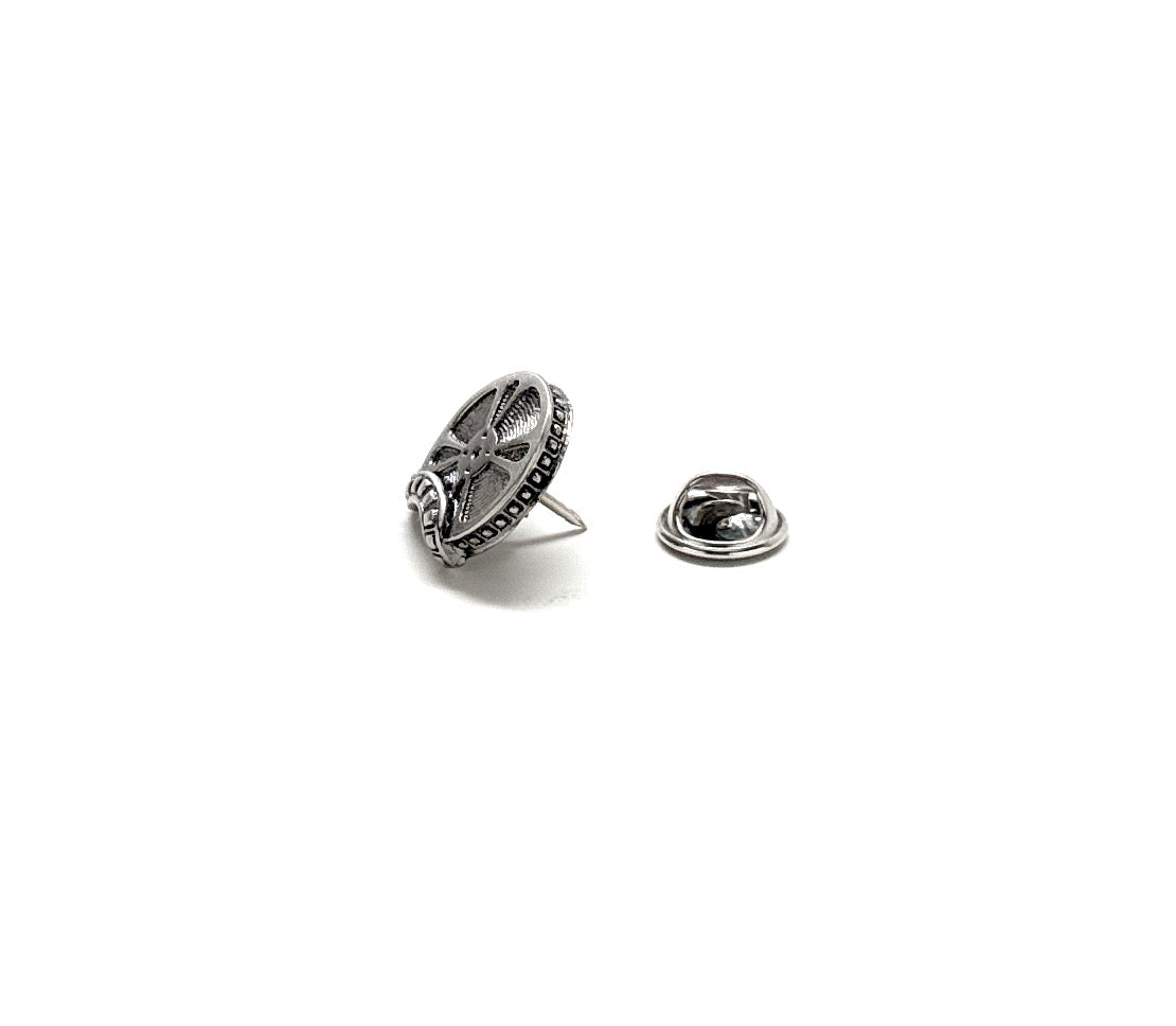 Silver brooch and matching lapel pin on a white background