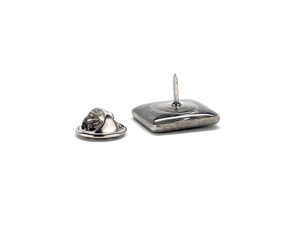 Two metal push pins on a white background