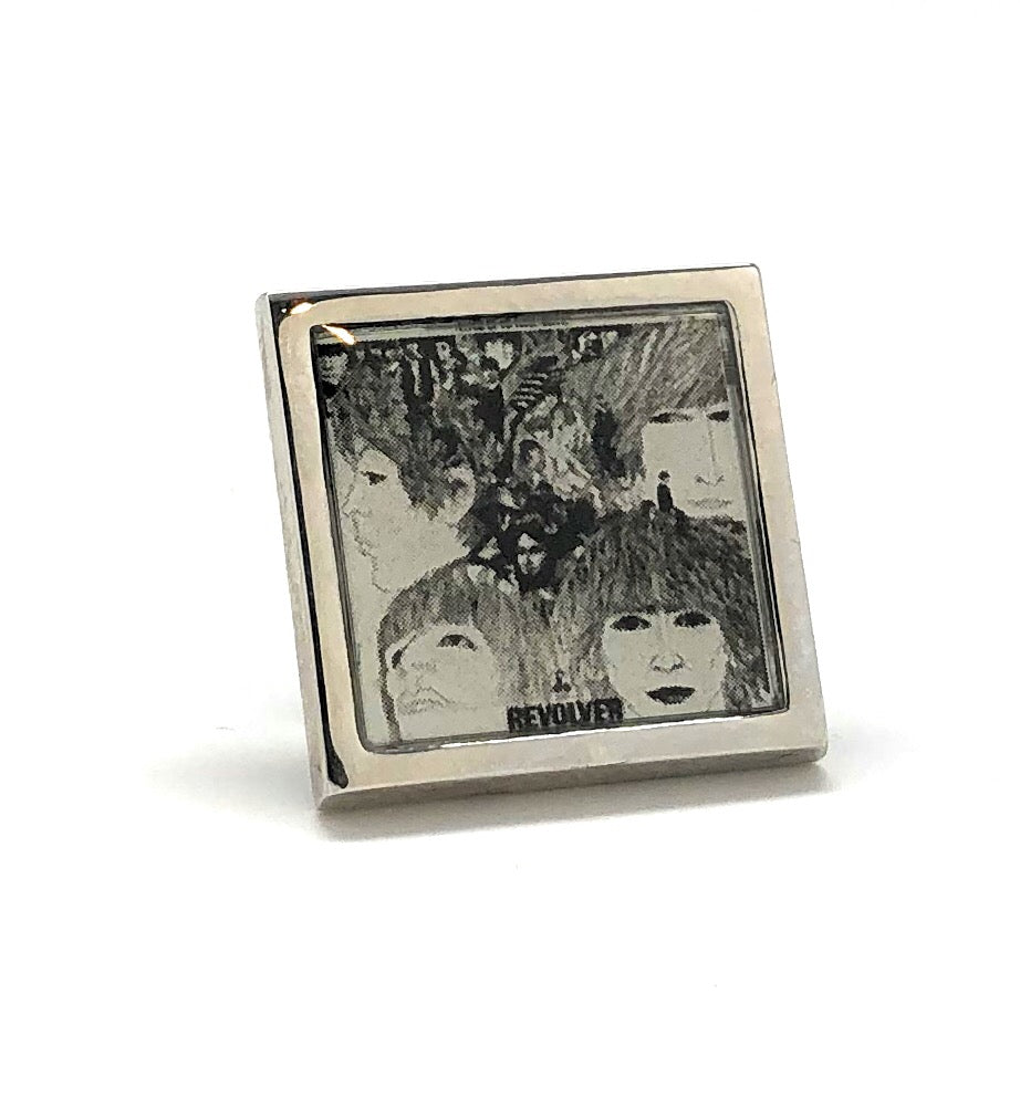 Metallic square coaster with Beatles album cover design on a white background
