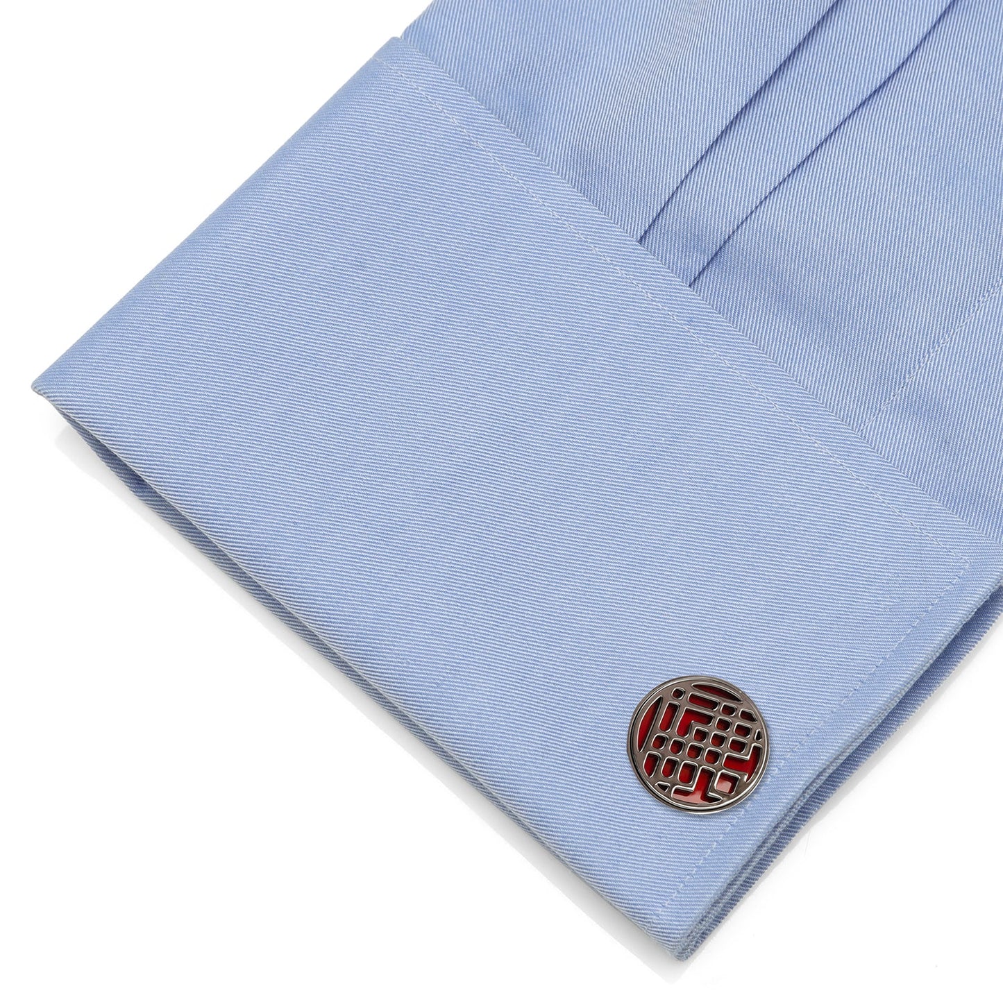 Cufflink on a light blue shirt cuff Red enamel Shang-Chi cufflinks close-up
