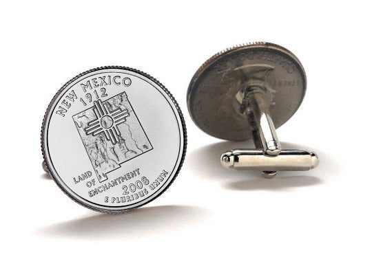 A pair of silver cufflinks featuring the design of a New Mexico state quarter coin with an inscription that reads 'NEW MEXICO 2008'.