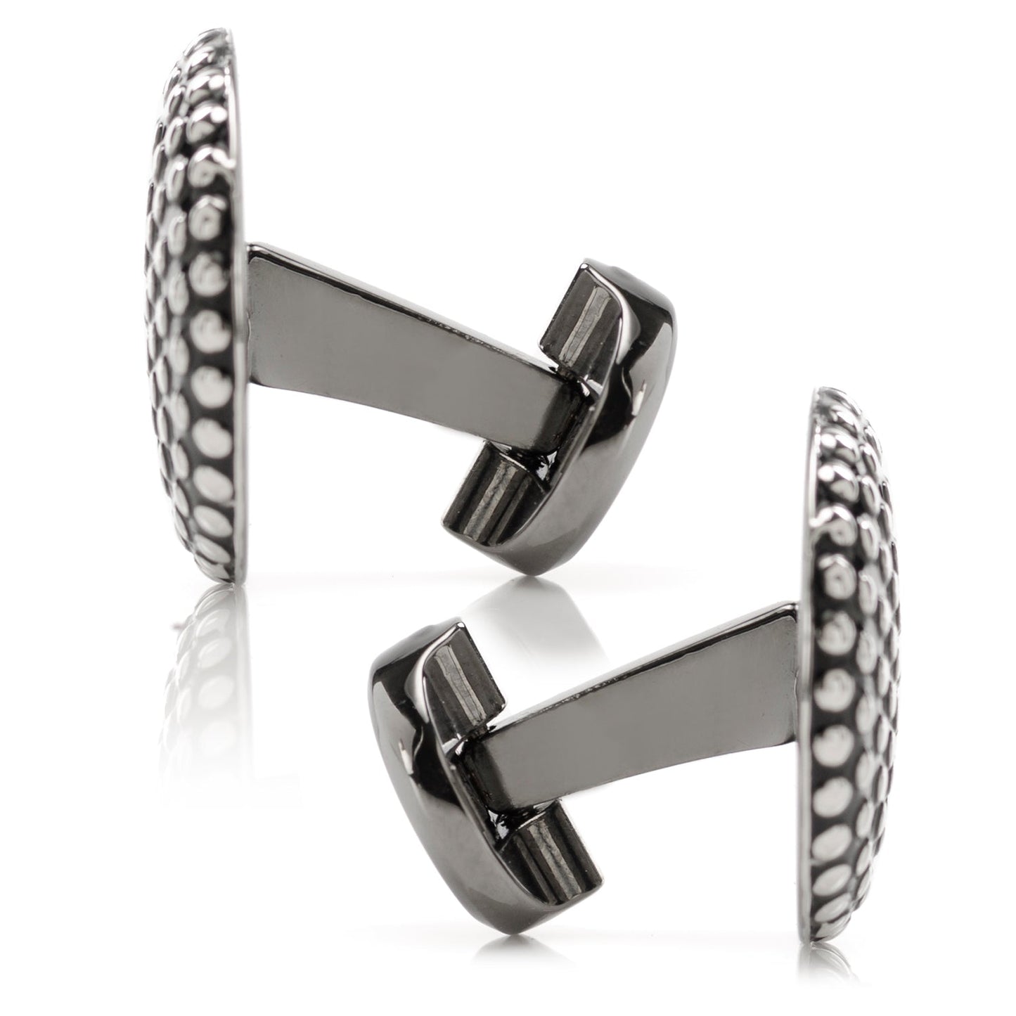 Pair of silver cufflinks with intricate design on a white background