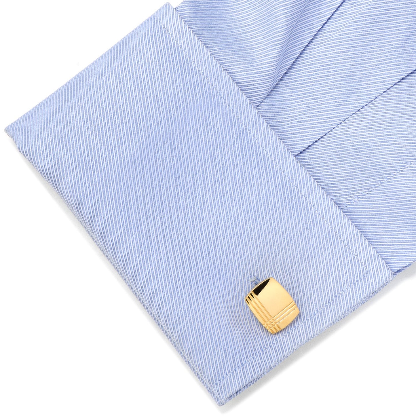 Gold cufflink on a light blue striped shirt
