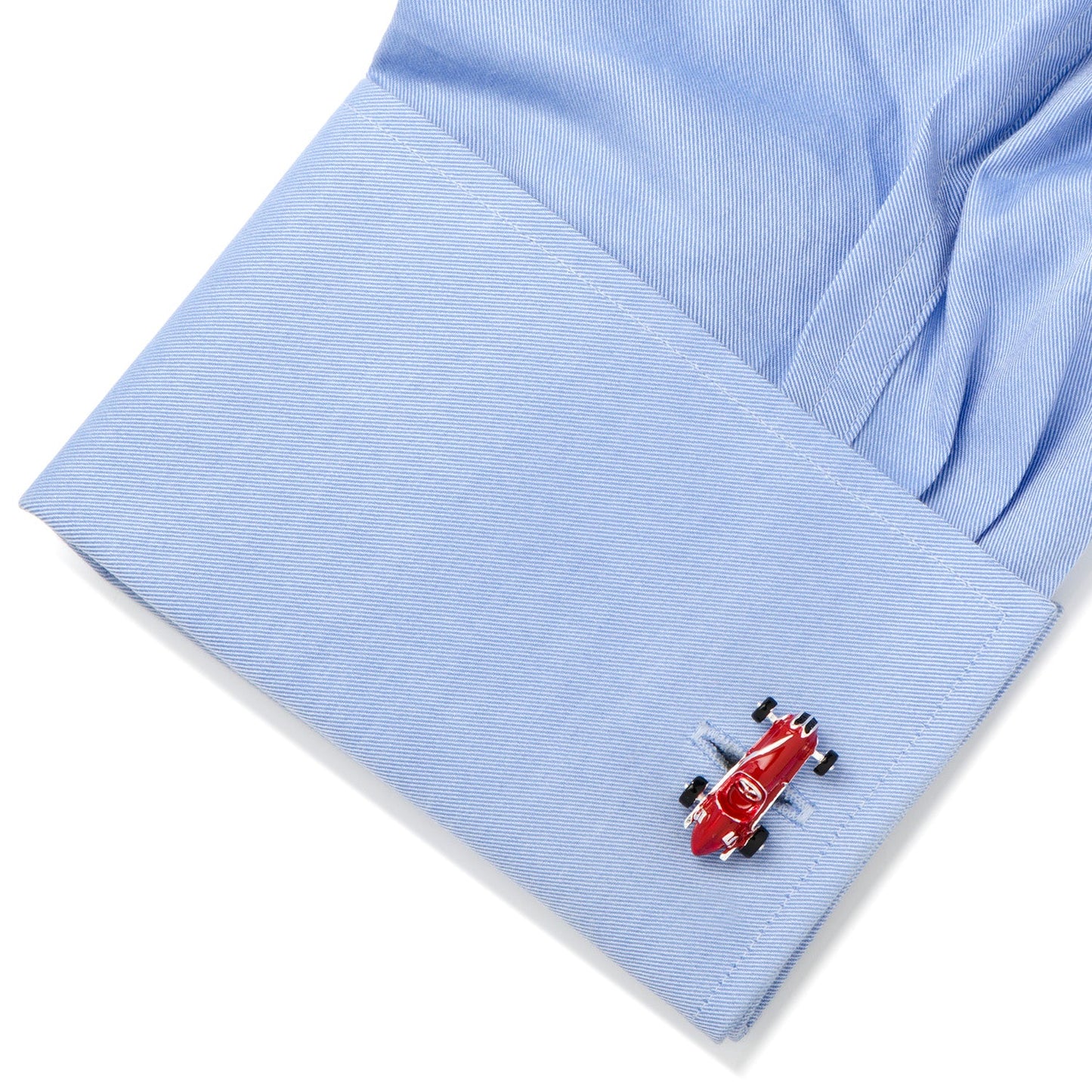 Red airplane cufflink on a light blue shirt sleeve