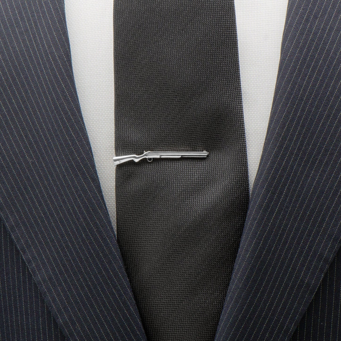 Close-up of a suit with a tie clip on a white background