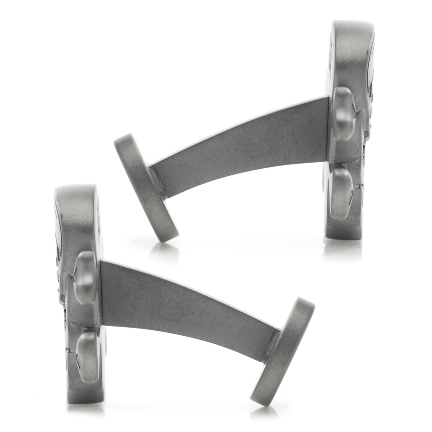 Metallic cufflinks on a white background