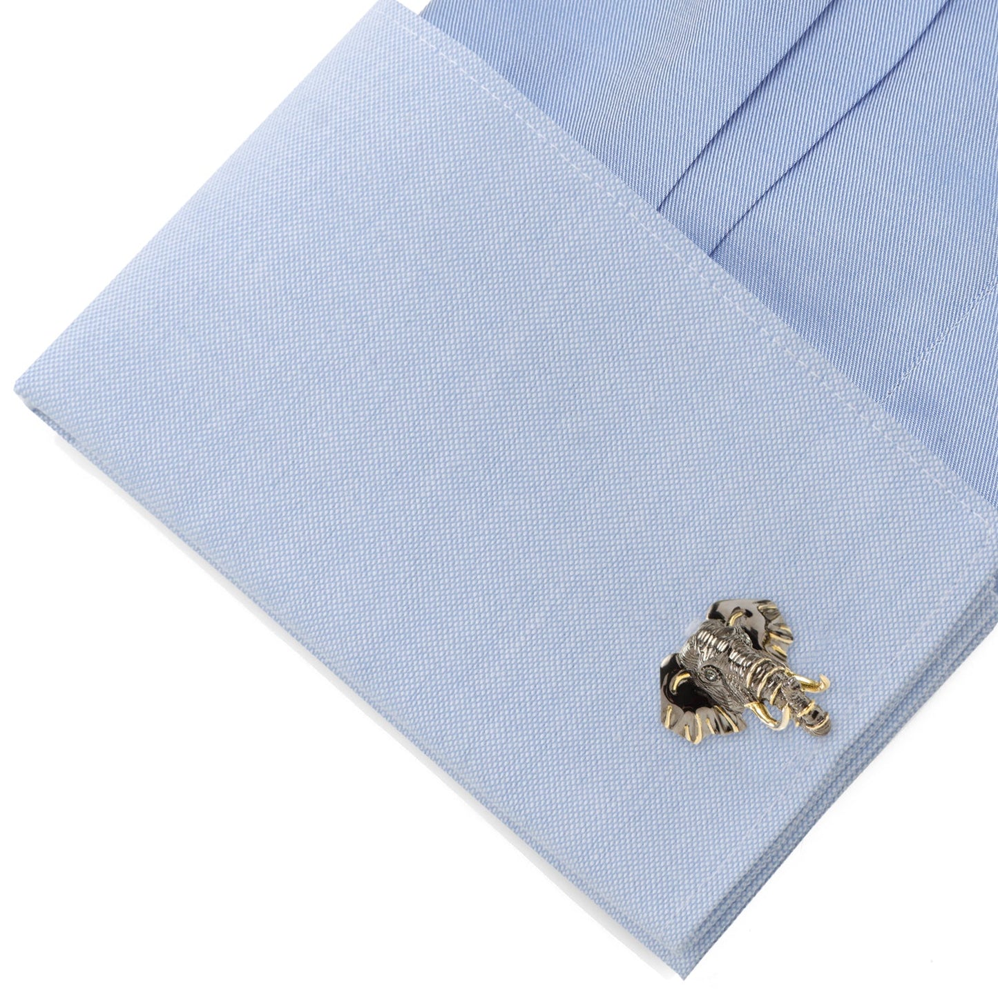 Gold cufflinks on a light blue dress shirt