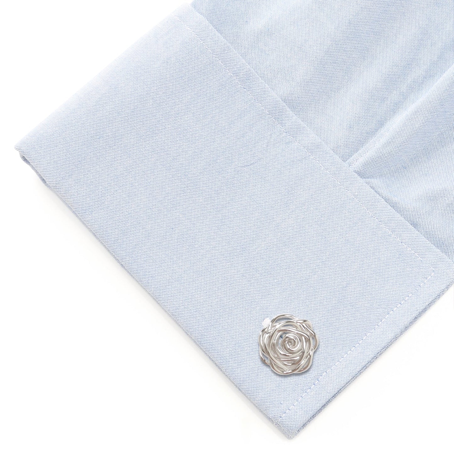 Light blue pocket square with a silver rose-shaped cufflink on a white background