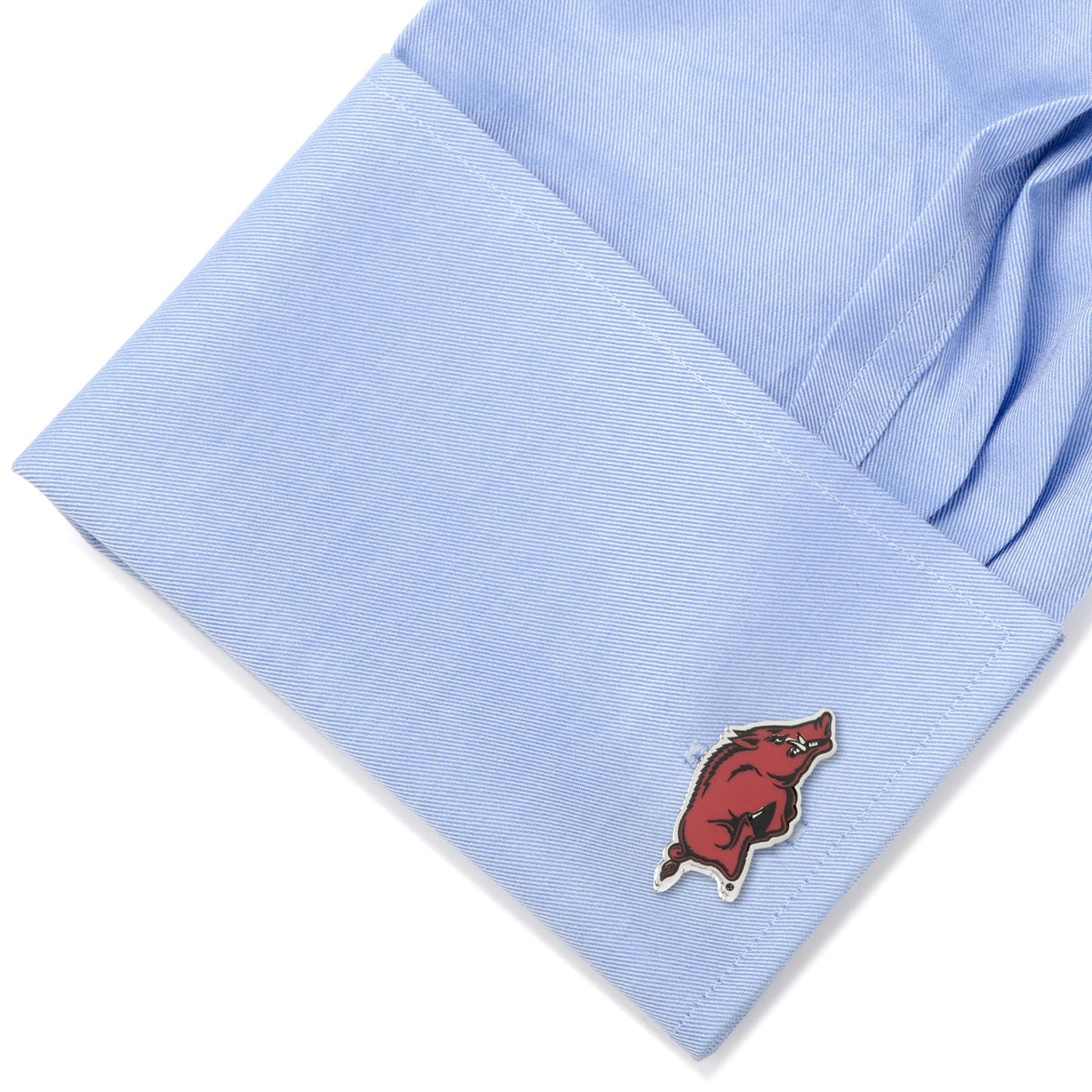 Light blue shirt cuff with a red and black logo on a white background