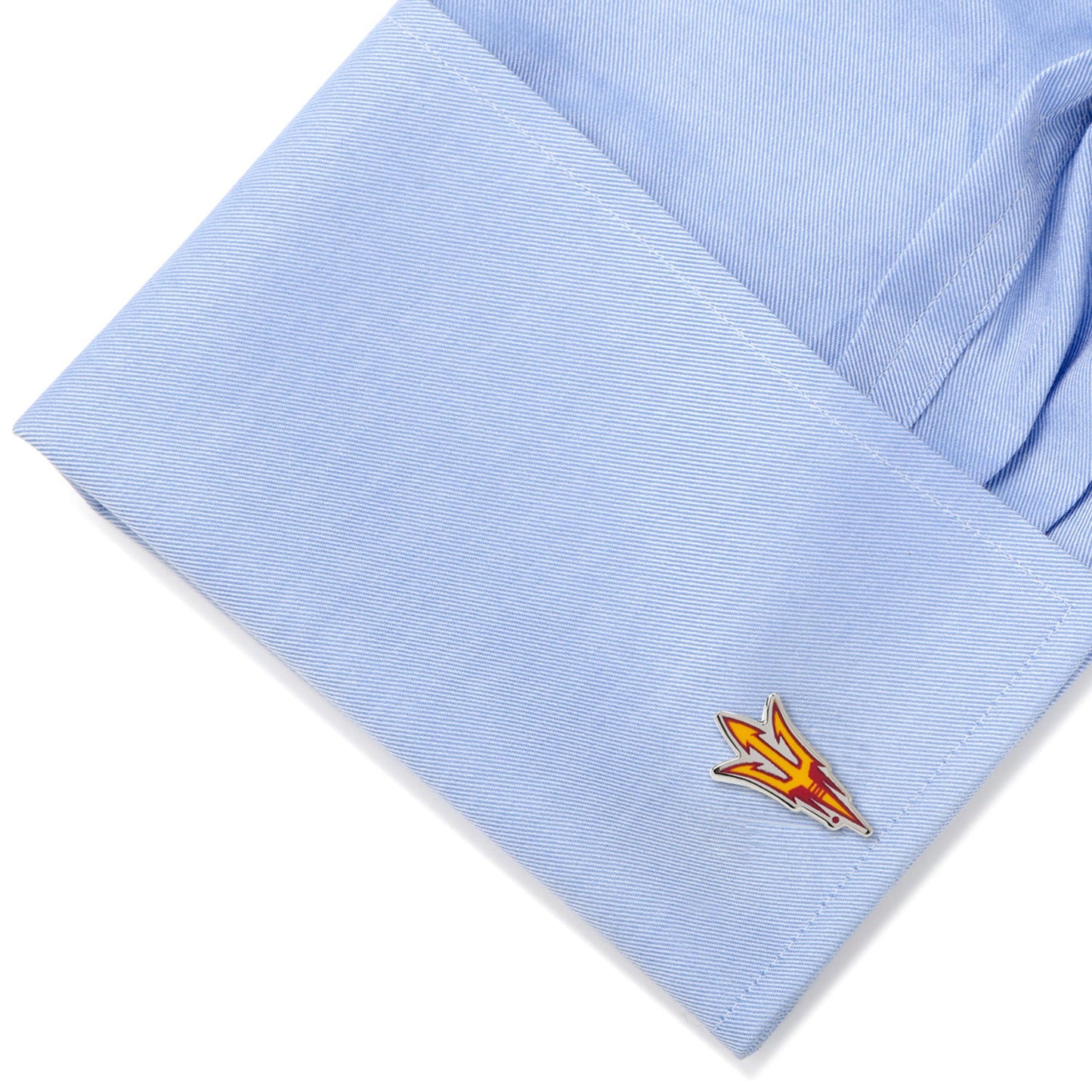Cufflink on a light blue shirt with a white background