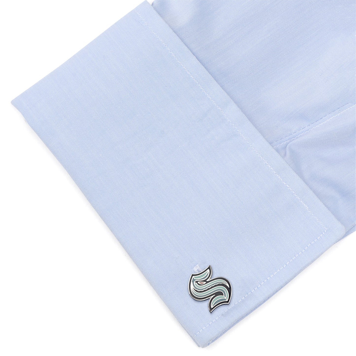 Light blue dress shirt with a cufflink on a white background
