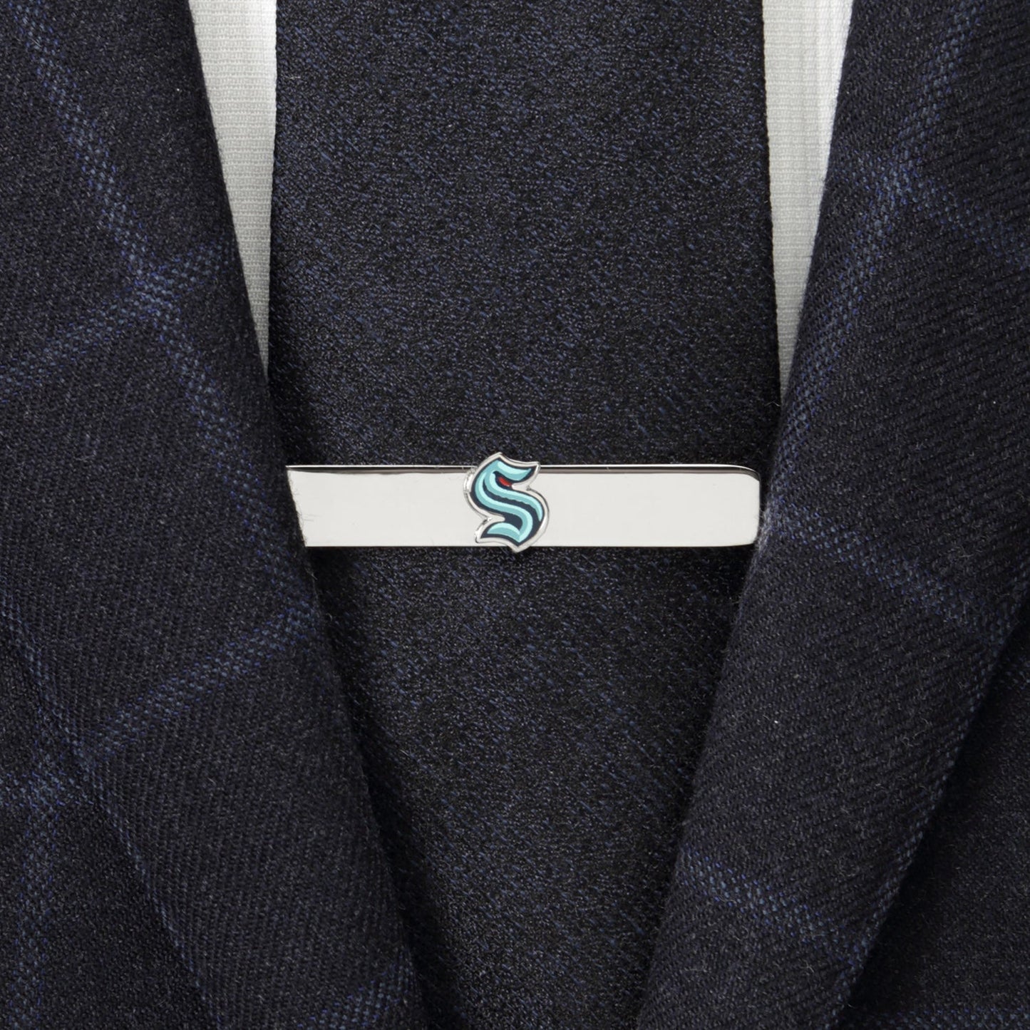 Tie clip with a logo on a suit jacket