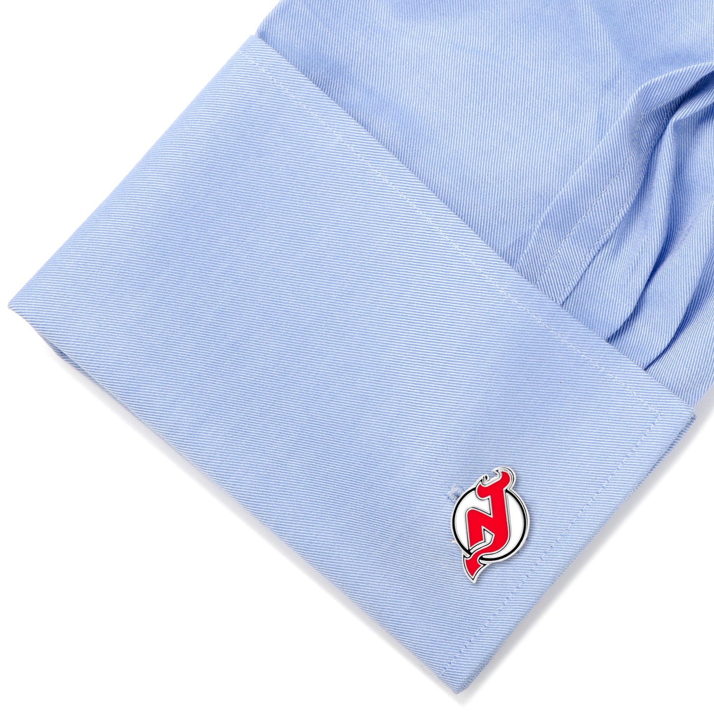 Cufflink with a red and silver design on a light blue shirt sleeve