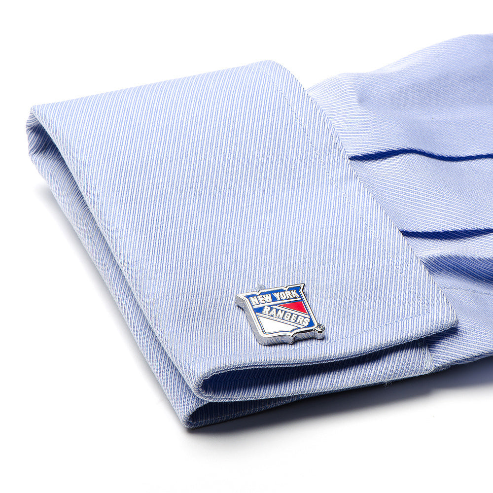 Folded light blue shirt with New York Rangers logo on cufflink