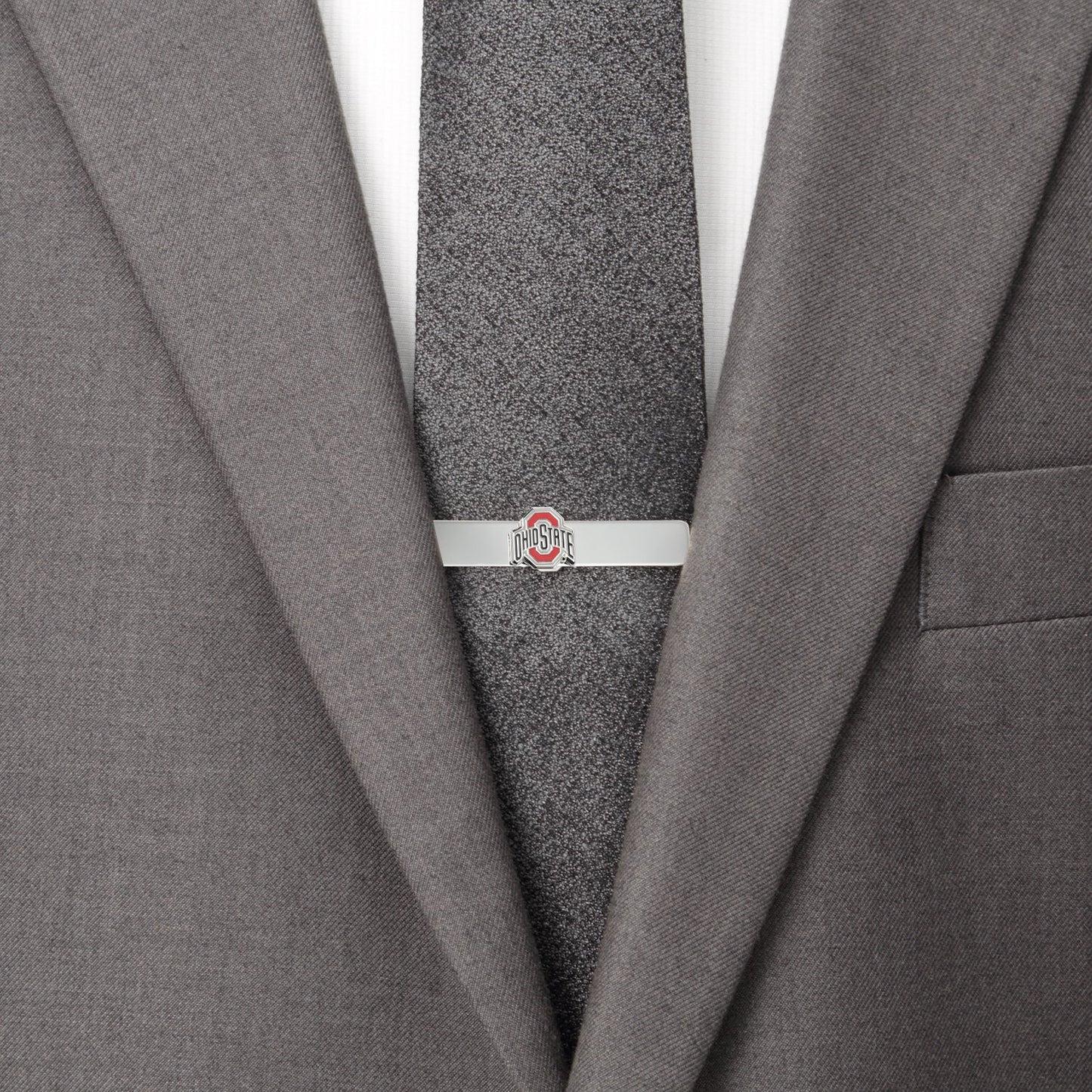 Gray suit jacket with a gray tie and a silver tie clip on a white background