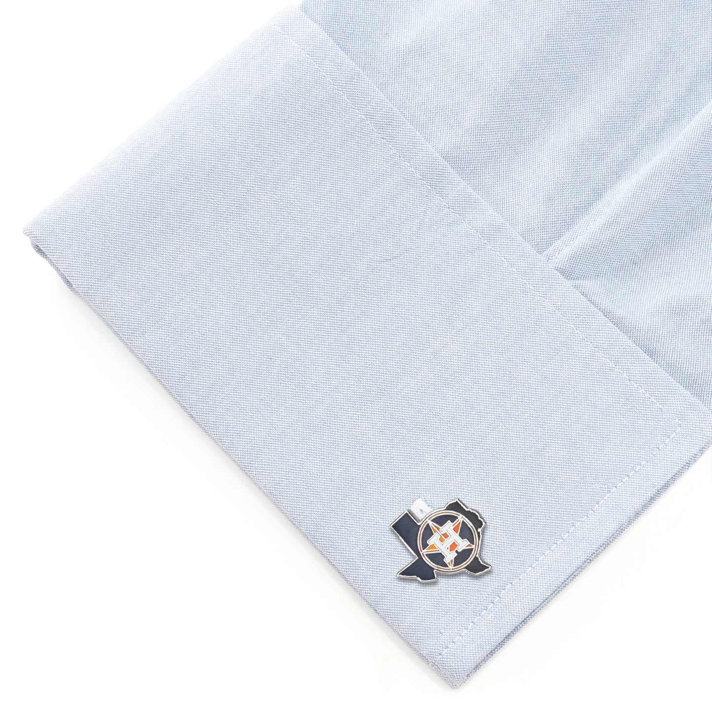 Cufflinks on a light blue textured fabric background