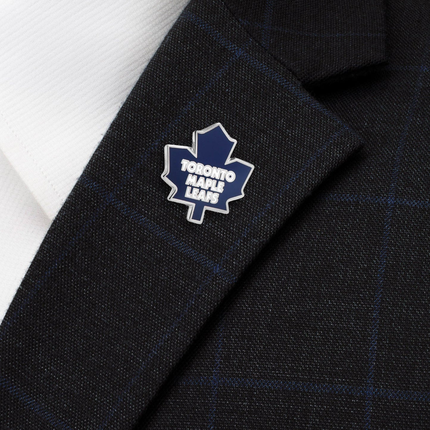 Toronto Maple Leafs logo on a dark suit jacket