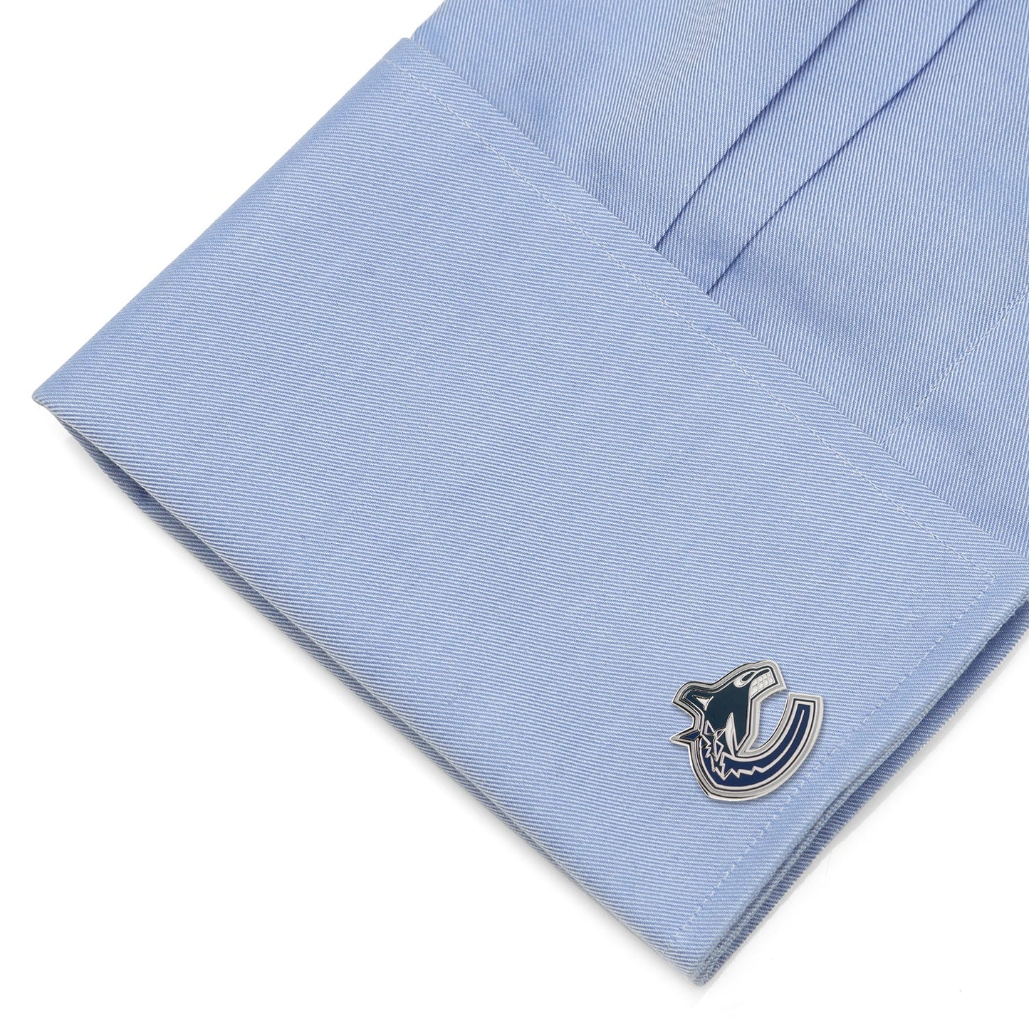 Cufflink on a light blue dress shirt