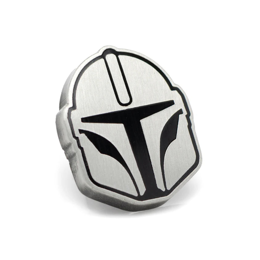 Metallic badge with a helmet design on a white background
