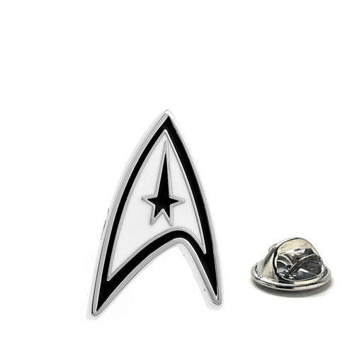 A lapel pin featuring the Starfleet emblem from Star Trek, with a black and white color scheme. The pin is next to a small, circular metal backing.