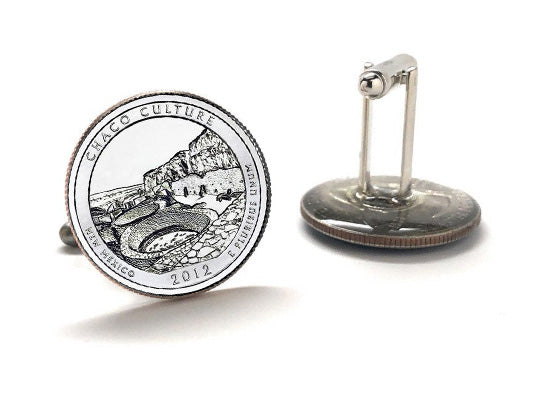 A pair of silver-colored cufflinks featuring an engraved design of the Chaco Culture National Historical Park quarter with a year 2012 inscription.