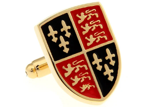 Shield-shaped cufflink with gold border, black, red, and gold design on a white background