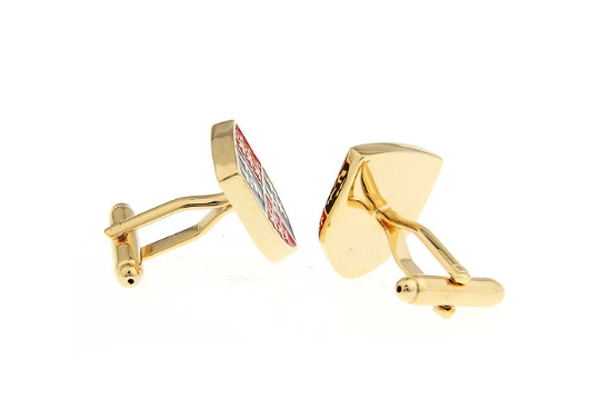 Gold cufflinks with a red gemstone on a white background