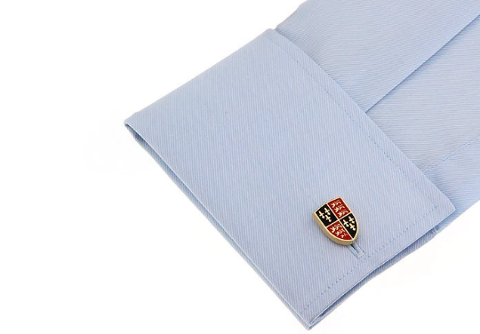 Cufflink on a light blue shirt with a white background