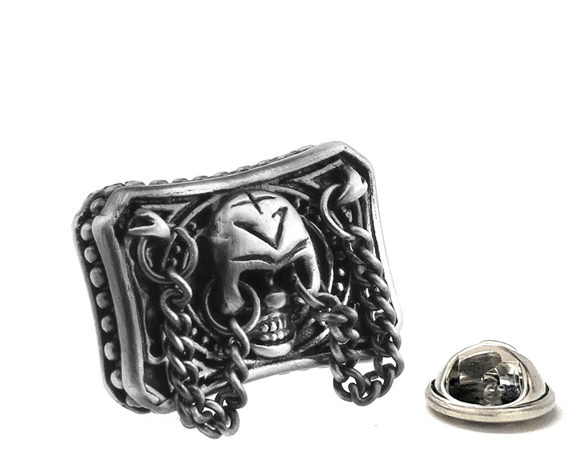 Silver skull and chain design lapel pin on a white background
