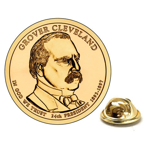 A gold-colored, enamel pin shaped like a dollar coin with an engraved portrait of Grover Cleveland, the 24th President of the United States, and the inscription 'In God We Trust' along with the date '1897-1908'.