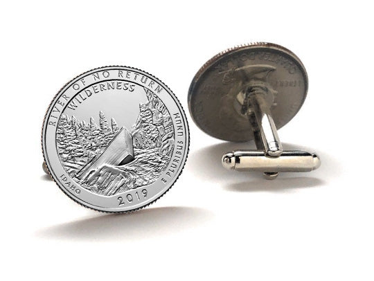 front and back A set of two silver coin cufflinks featuring an image of a wilderness scene with trees and a mountain.