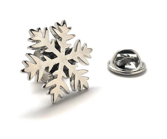Silver snowflake-shaped lapel pin on a white background