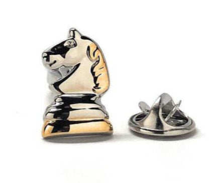 A silver and gold plated chess knight lapel pin with a clutch back closure.