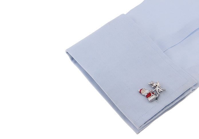Cufflinks and pocket square set on a light blue fabric background