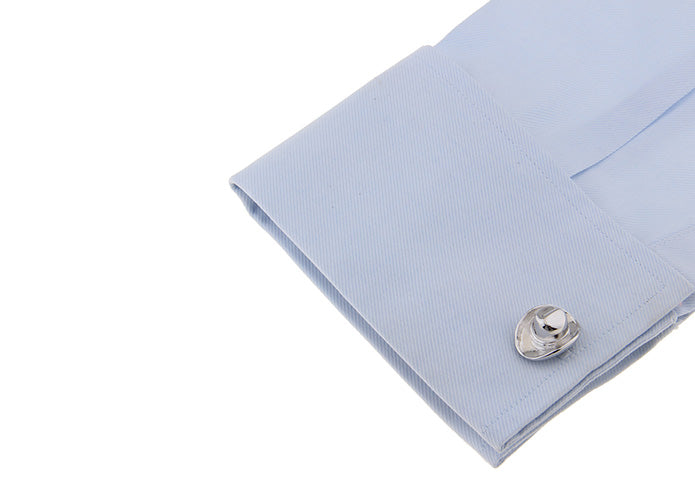 Light blue dress shirt cuff with a silver cufflink on a white background