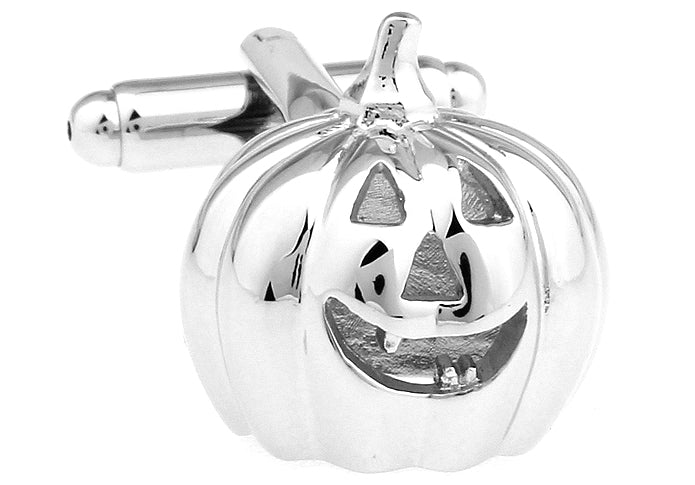 Silver pumpkin-shaped cufflinks with a jack-o'-lantern face on a white background