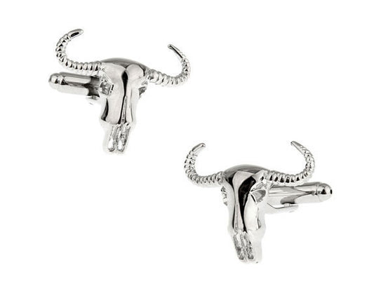 Silver bull head cufflinks on a white background